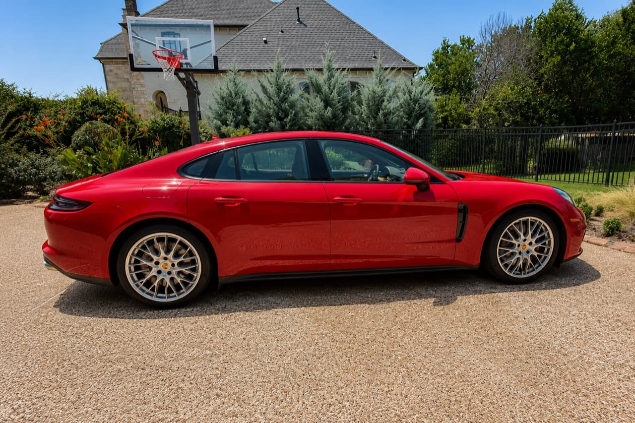 Red Porsche Panamera exterior, dusty before and gleaming after a detail — after